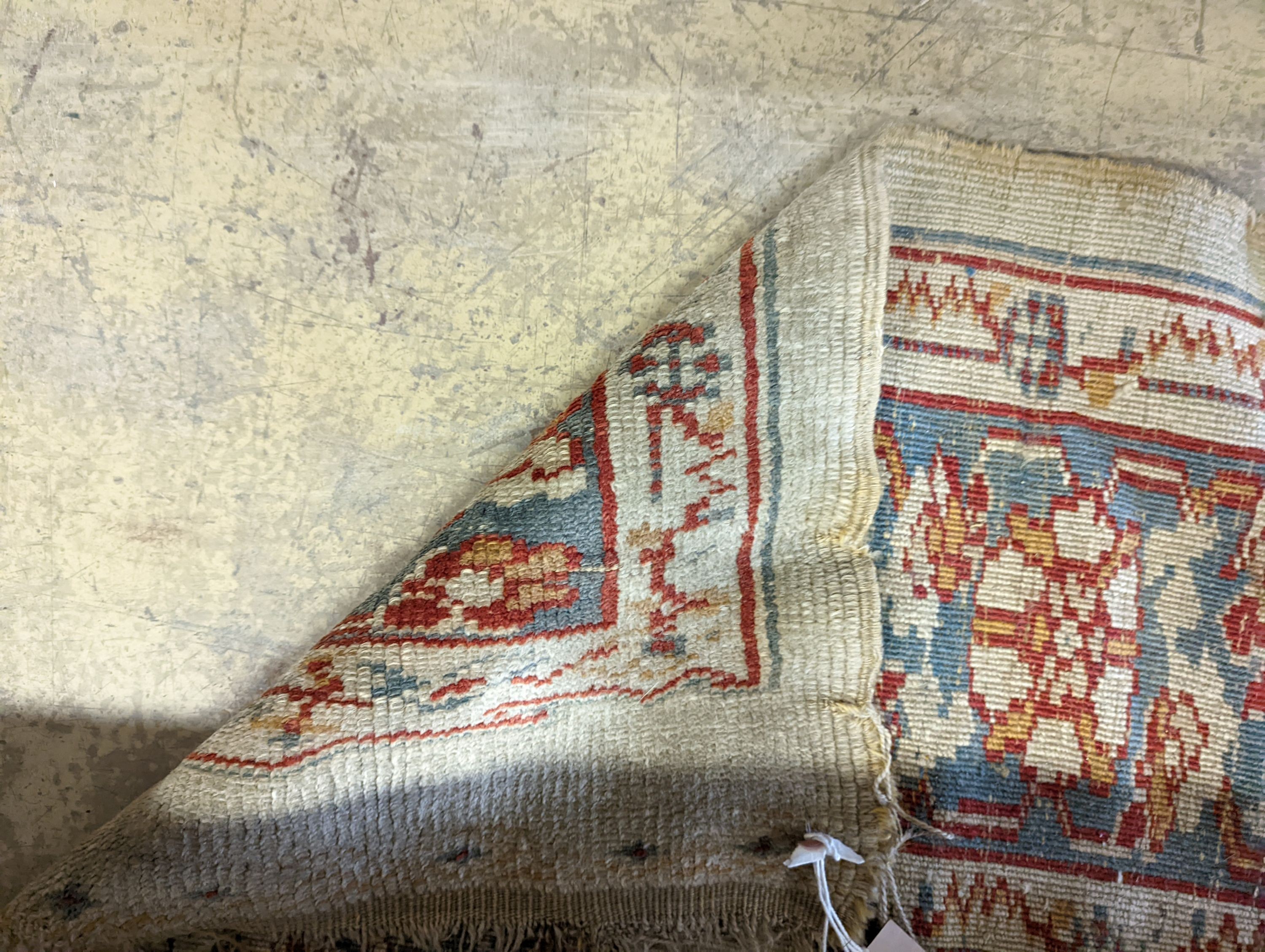 An antique Turkish? ivory ground rug, 218 cm long, 145 cm wide